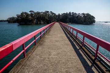 Fototapeta premium Red railings on bridge to Fukuurajima, a small island on the coast of Japan