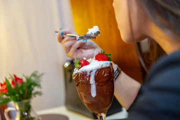 Ice cream white blends strawberry with high calories, can make you fat, soft focus, blurred. Delicious vanilla or chocolate sundae with strawberry.