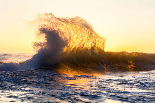 Waves splashing in sea with sunlight