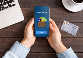 Woman holding smartphone with digital wallet application