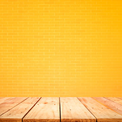 Empty wood table top with yellow brick wall background.For create product display or design key visual