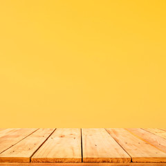 Empty of wood table top on yellow pastel color background