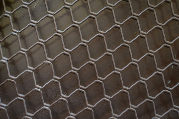 Background of dark grey - black metallic fence with geometric model