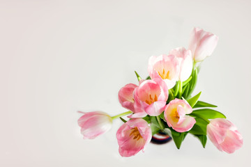 Wedding mockup with pink paper list and tulip flowers on blue table top view. Beautiful floral. Flat lay style.
