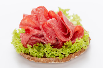 Sandwich with salami sausage on white background.