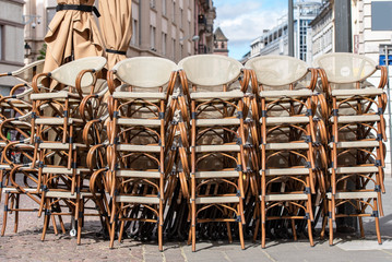 Rows of traditional Chairs of a Street Cafe in France, french furniture in a Street 