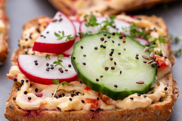 Sandwiches with cream cheese, vegetables and salami.