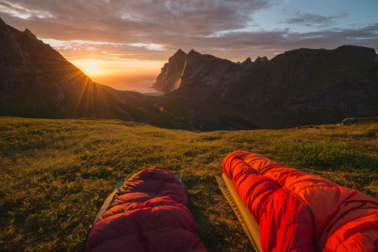 Colorful summer sunset over Bunes beach seen from sleeping bags