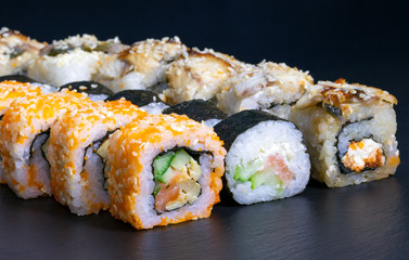 sushi set rolls with salmon eel cheese cucumber rice sauce sesame caviar