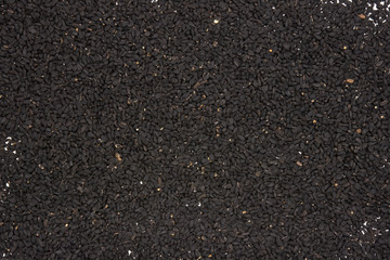 Closeup lot of whole black cumin seeds flatlay isolated
