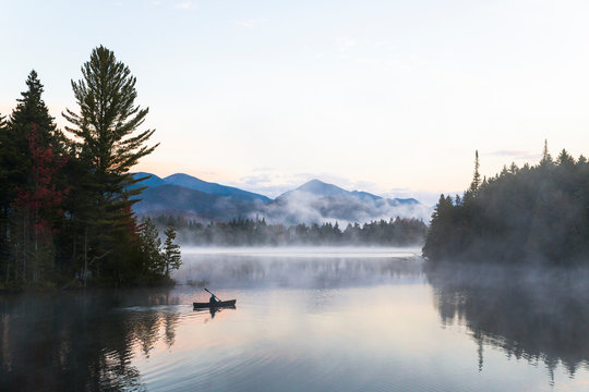 Canoeing On The Boreas Pond With The Adirondack High Peaks Range To The North