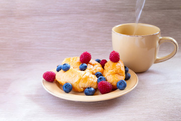 fresh juicy summer berries raspberry and blueberry with drops of honey in a natural beige cotton cloth. 