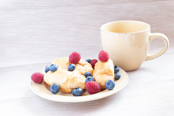 fresh juicy summer berries raspberry and blueberry with drops of honey in a natural beige cotton cloth. 
