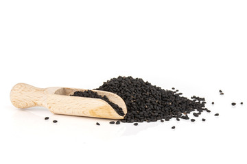 Lot of whole black cumin seeds with wooden scoop isolated on white background