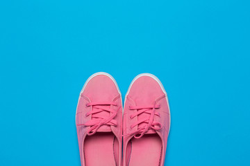 Sneakers on blue background. Fashion blog or magazine concept.