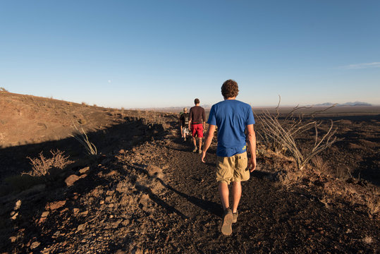 Group of people hiking on ridge of crater, Sonora, Mexico