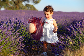 Girl in dress with hat in lavender field