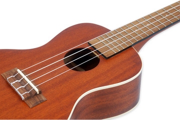 Obraz na płótnie Canvas The brown ukulele on the white Background, close-up photo with Clipping path