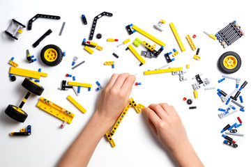 Kid hands making robot car. Robotic, learning, technology, stem education for children background