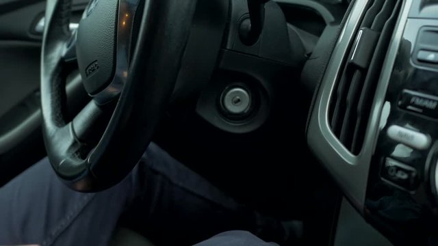 the guy's hand turns and pulls the key out of the ignition and turns off the engine. Driver turn off engine