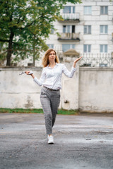 young beautiful woman walk on street spend time on fresh air