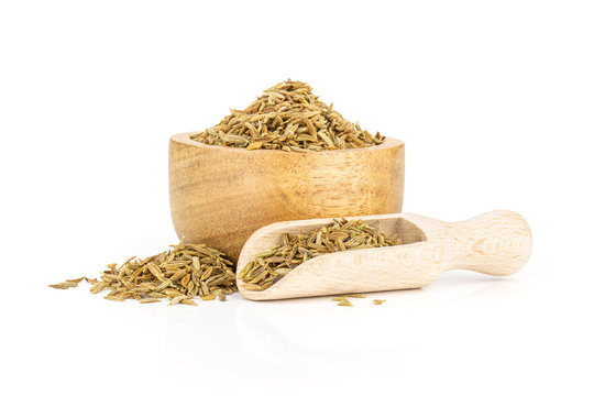 Lot of whole roman caraway seeds in a wooden scoop with wooden bowl isolated on white background