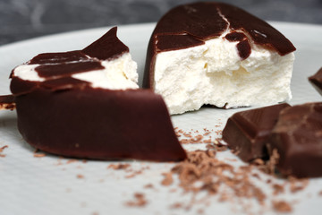Chocolate butter ice cream popsicles on the white plate with chocolate chip
