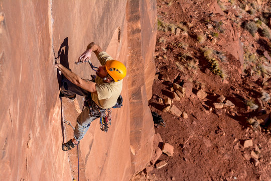 A man rock climbing in Indian Creek, Monticello, Utah.
