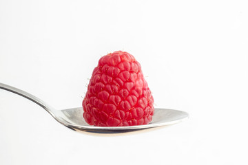 Vivid raspberry in spoon closeup