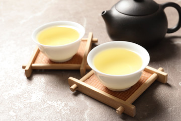 Cups of Tie Guan Yin oolong tea on table. Space for text