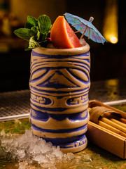 Tropical cocktail tiki bar style.  Alcoholic, non-alcoholic drink-beverage at the bar