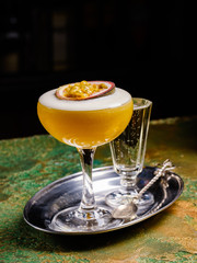 Fresh tropical cocktail with passion fruit. Alcoholic, non-alcoholic drink-beverage at the bar