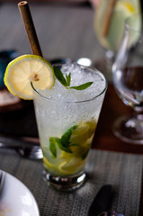 Drink/cocktail on table with straw & ice.