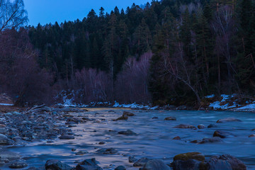 Sunset of the day over the mountain river