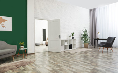 Living room interior with stylish furniture and open door