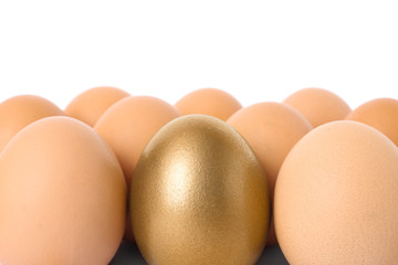 Golden egg among others on white background