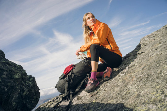 Woman hiking on a rocky ridgeline in New England.