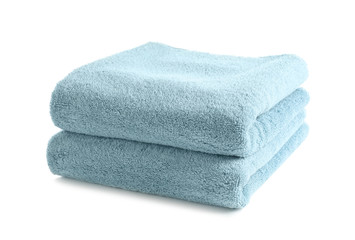 Folded clean soft towels on white background