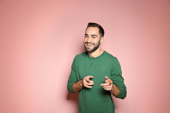 Portrait Of Handsome Young Man On Color Background