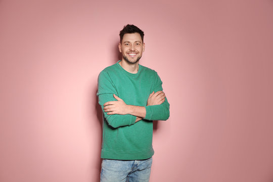 Portrait of handsome man in stylish clothes on color background