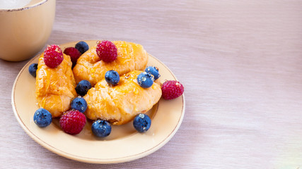 fresh juicy summer berries raspberry and blueberry with drops of honey in a natural beige cotton cloth. 