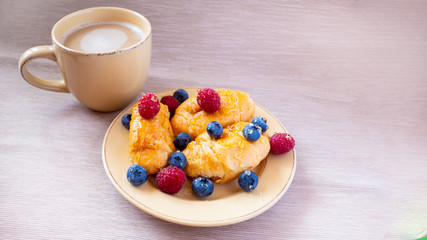 fresh juicy summer berries raspberry and blueberry with drops of honey in a natural beige cotton cloth. 