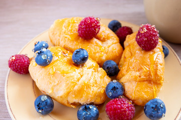 fresh juicy summer berries raspberry and blueberry with drops of honey in a natural beige cotton cloth. 