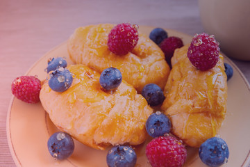 fresh juicy summer berries raspberry and blueberry with drops of honey in a natural beige cotton cloth. 