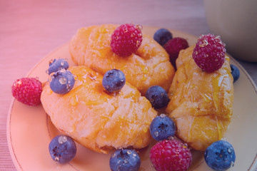 fresh juicy summer berries raspberry and blueberry with drops of honey in a natural beige cotton cloth. 