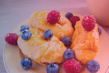 fresh juicy summer berries raspberry and blueberry with drops of honey in a natural beige cotton cloth. 