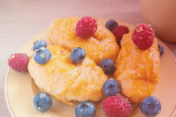 fresh juicy summer berries raspberry and blueberry with drops of honey in a natural beige cotton cloth. 