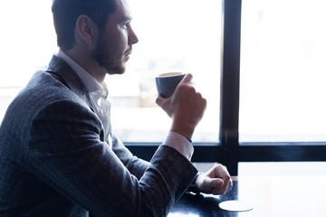 Business man drinking coffee in a cafe - coffee time.