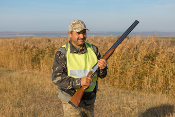 Hunters with a german drathaar and spaniel, pigeon hunting with dogs in reflective vests	