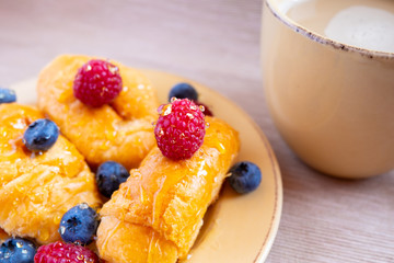 fresh juicy summer berries raspberry and blueberry with drops of honey in a natural beige cotton cloth. 